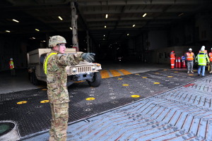 US Army military vehicles leaving the ship via a stern ramp. Photo: Sgt.1st Class Jacob McDonald